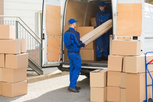 Removal van loading a compact flat move in West Hampstead