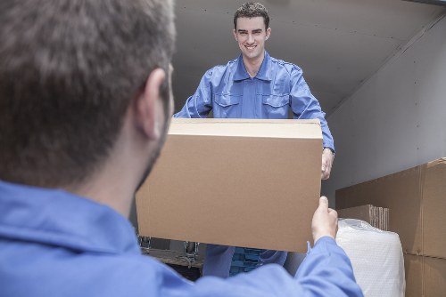 Furniture removals team handling a move in West Hampstead street setting