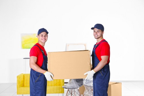 Moving team preparing furniture for transport in West Hampstead
