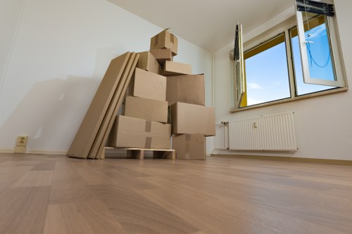 Removal van and moving team working in West Hampstead street