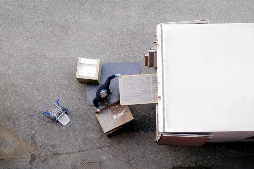 Removal team handling boxes and household items in West Hampstead