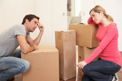 Staff assessing hazards and handling boxes carefully during a move