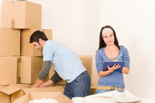 Packed boxes and furniture ready for house removals in a West Hampstead flat
